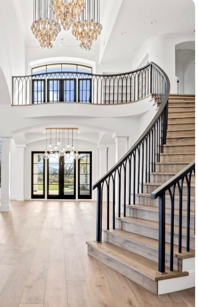 Custom curved interior staircase with black steel railing, North Hollywood