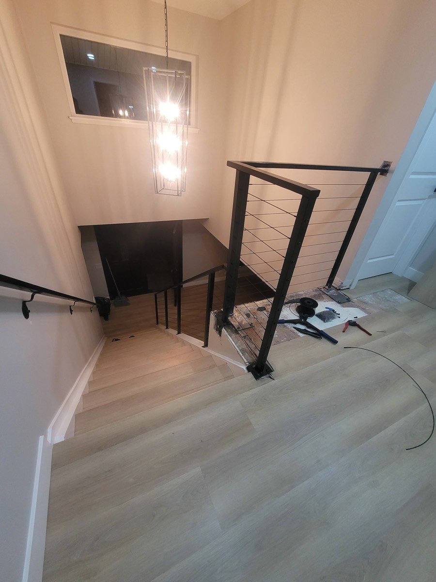 Modern interior staircase with steel cable railing